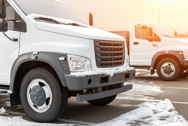 New middle size trucks at dealership parking outdoors at winter. Truck service and maintenance. Delivering and warehouse service.